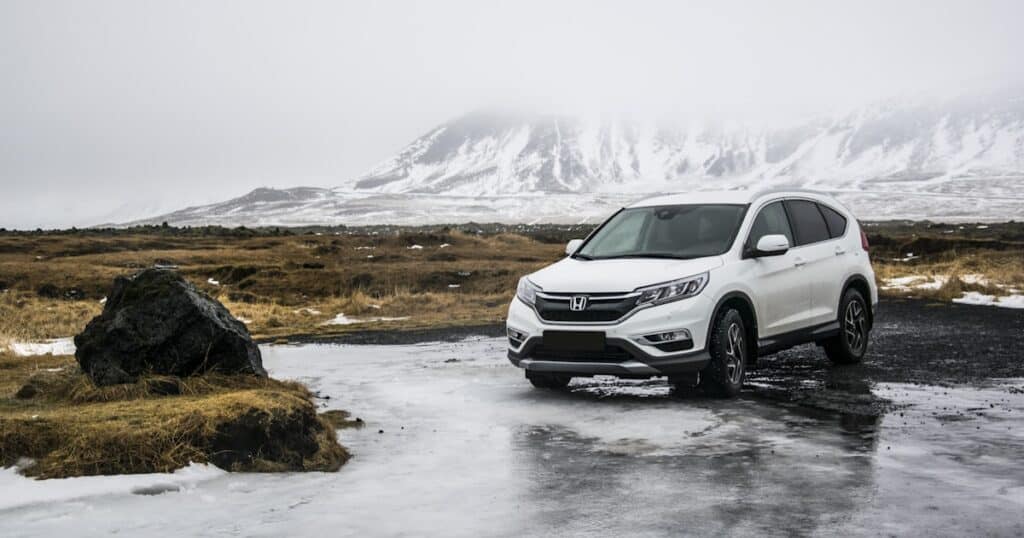SUV familial hybride rechargeable stationne sur une route de campagne